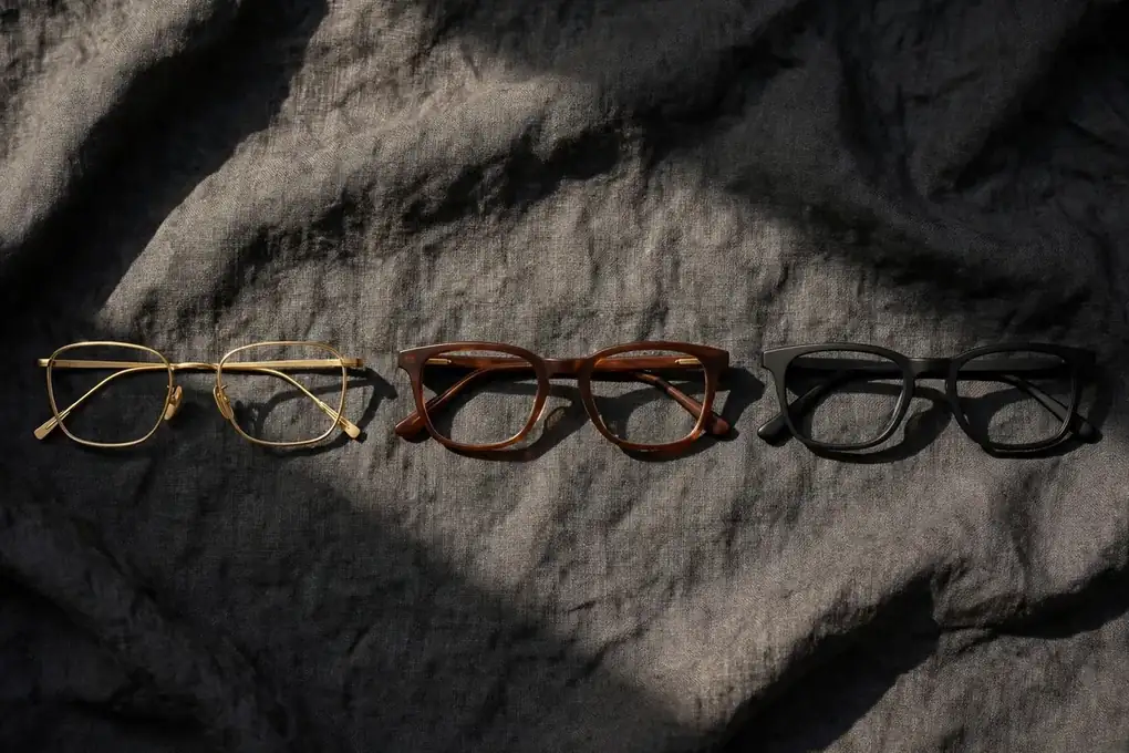 Premium acetate frame with polished bevels resting on a dark surface